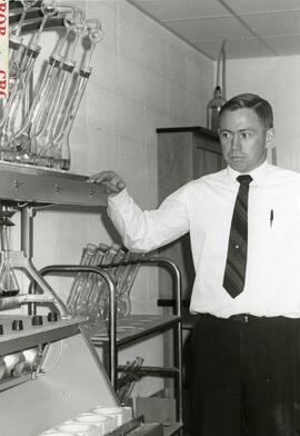 Person in front of beakers