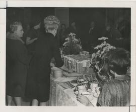 People standing around table in Rodli Commons, n.d.