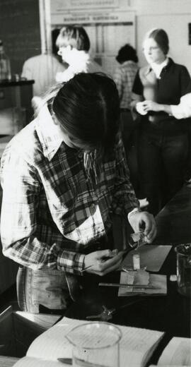 Student pouring liquid from beaker