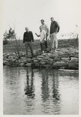 Four men standing alongside the South Fork.