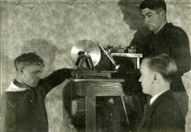 Three people using equipment