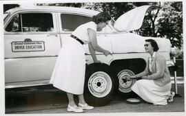 Changing a car tire in Drivers Education.