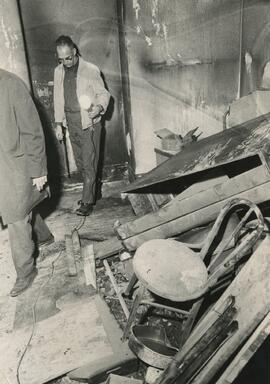 Tom Chapman reviewing damage from fire on the 3rd floor, 1970.