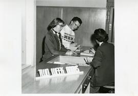 Students at the library reserve desk, circa 1970s.