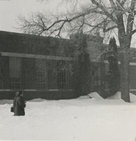 Person walking in front of the industrial arts building