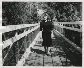 Student walking across the Swinging Bridge, circa 1960s.