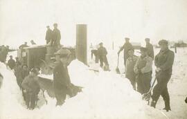 Men uncovering train from snow on the railroad, Woodville, Wisconsin