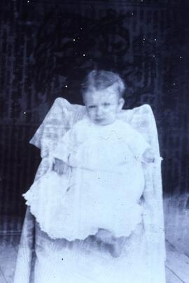 Art Olarry "Kelly baby" in chair, circa 1890