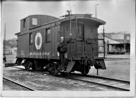 Hudson: railroads, George Joyce standing on caboose in Hudson, undated