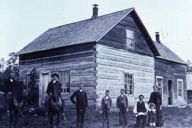 Sylvester and Lucy Hoyt Smith family outside of log house in Dunn County, circa 1890