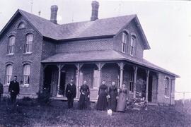 Mr. Hess [William?] and family outside of brick home near Rock Elm RTownship, circa 1890