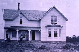 Albert Holcomb and family in front of family home in Rock Elm, circa 1890