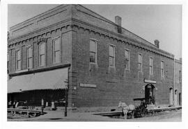 Horse and buggy outside Carroll business at North corner of Main Street and Walnut in River Falls...